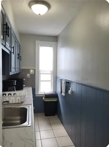 a kitchen with a stove a sink and a microwave