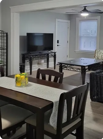 a kitchen with a table chairs and a refrigerator