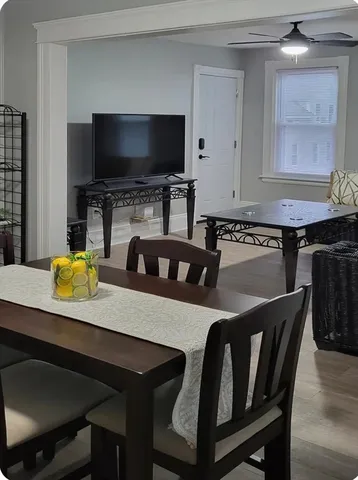 a kitchen with a table chairs and a refrigerator