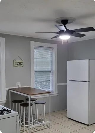 a kitchen with a refrigerator and a stove top oven