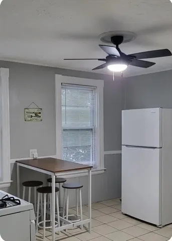 a kitchen with a refrigerator and a stove top oven
