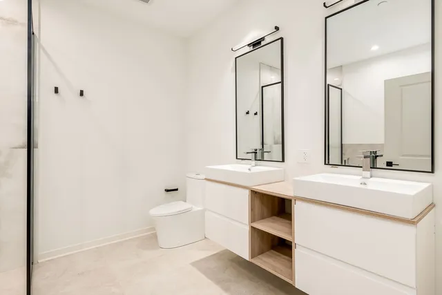 a bathroom with a sink toilet and mirror