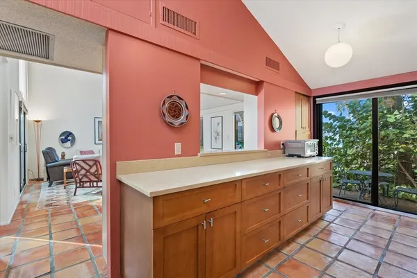 a spacious bathroom with a granite countertop sink and a mirror