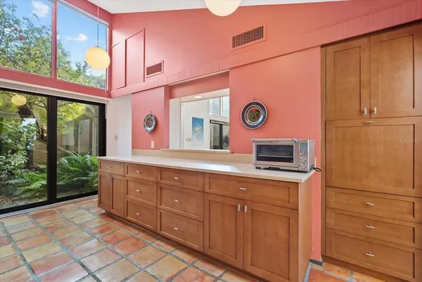 a bathroom with a sink a mirror and a bathtub next to a window