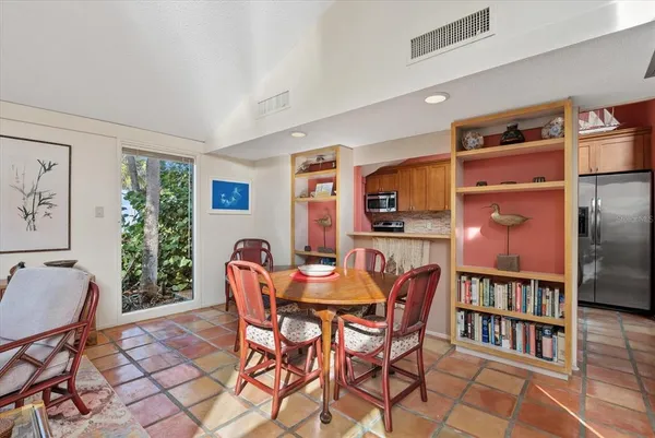a dining room with furniture and wooden floor
