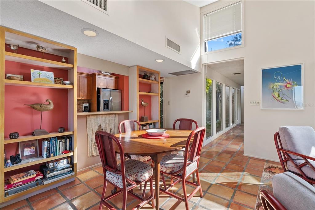 35 Sandy Cove Road, Unit 2A Sarasota, FL 34242 - Photo 19 of 49 a dining room with a table and chairs