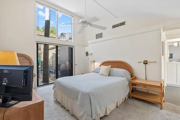 a bedroom with a bed and a night stand