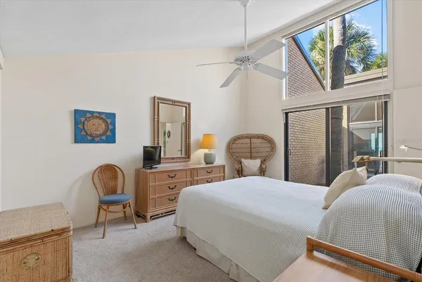 a bedroom with a bed a dresser and chair