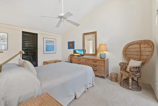 a bedroom with a bed a table and chair