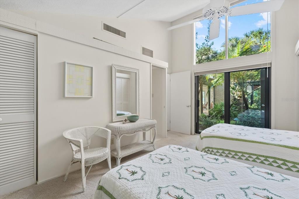 35 Sandy Cove Road, Unit 2A Sarasota, FL 34242 - Photo 28 of 49 a bedroom with a bed and a window