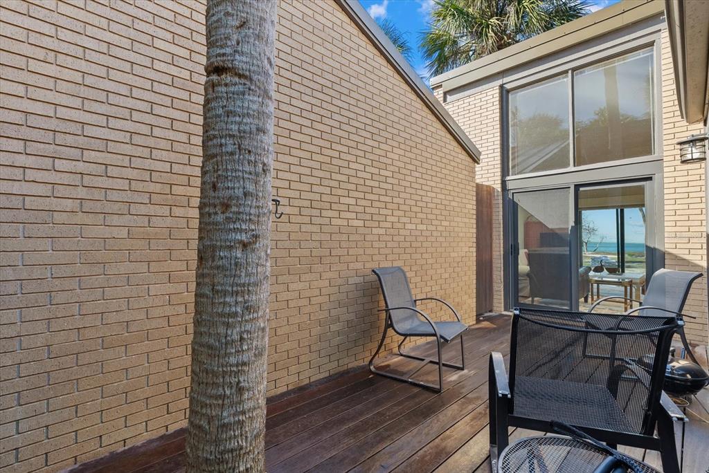 35 Sandy Cove Road, Unit 2A Sarasota, FL 34242 - Photo 31 of 49 a view of a outdoor seating area with wooden floor
