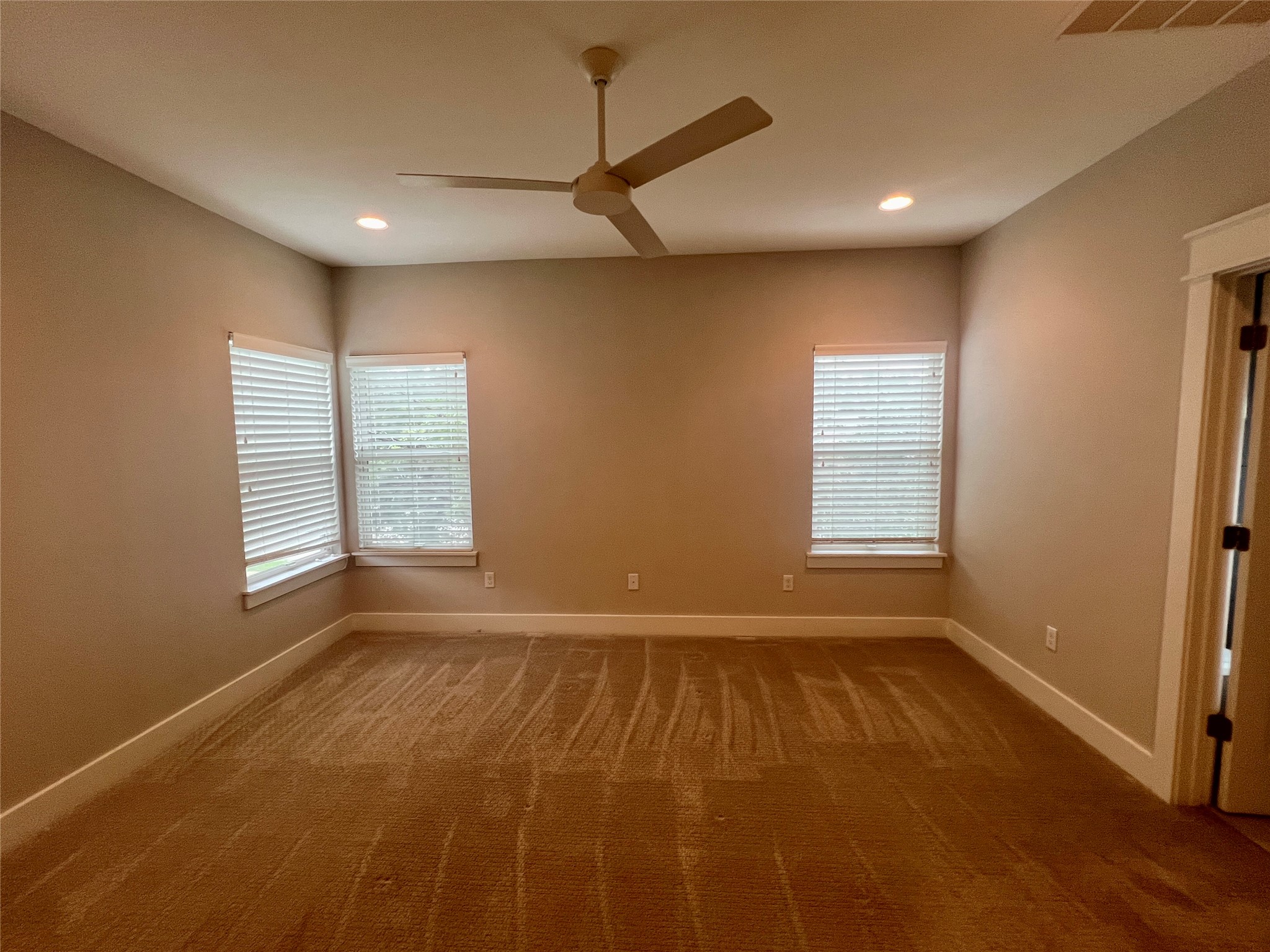 6515 Davis Lane, Unit 10 Austin, TX 78749 - Photo 10 of 22 A spacious bedroom featuring comfortable carpeting and abundant natural light from multiple windows.