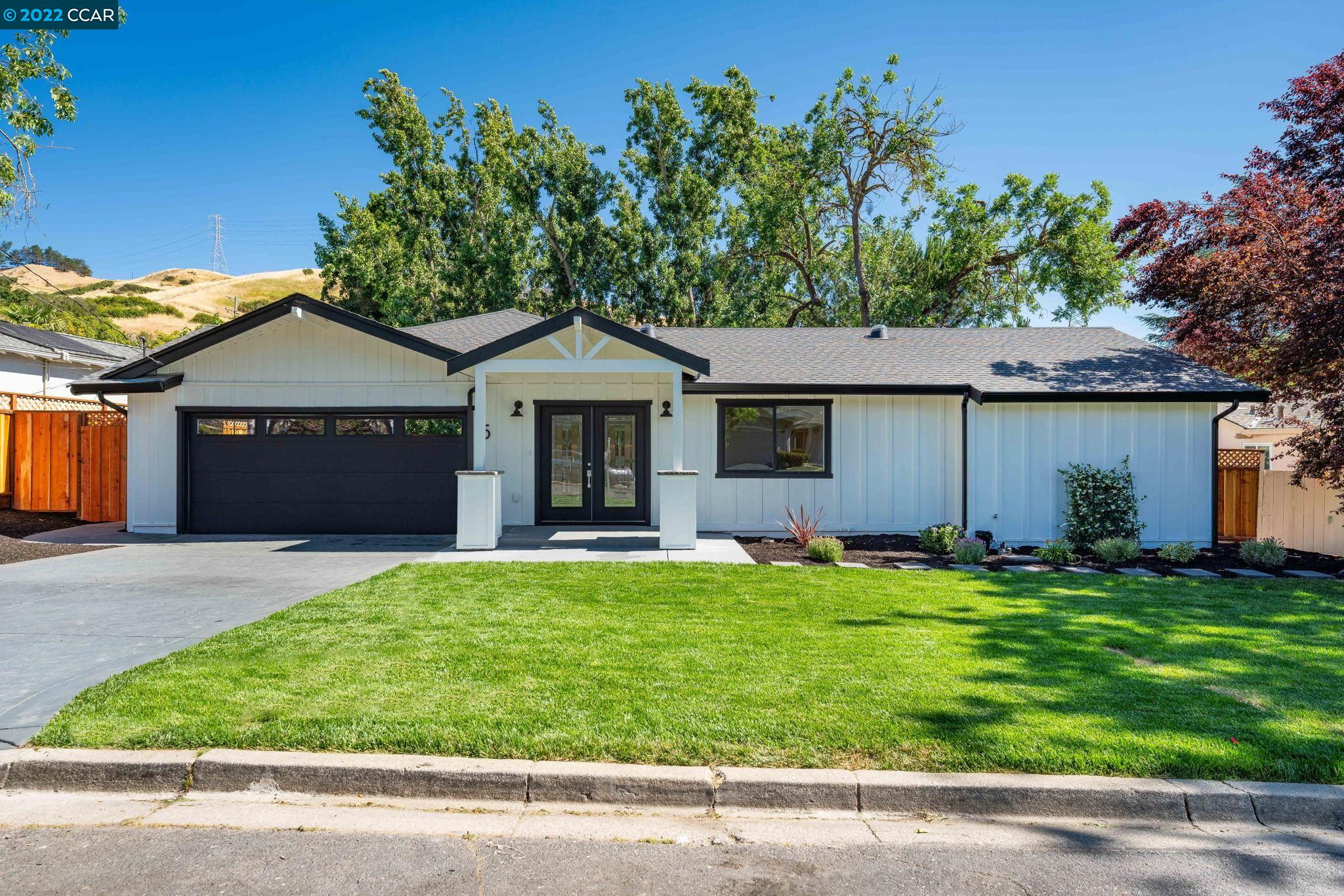 a front view of a house with a garden