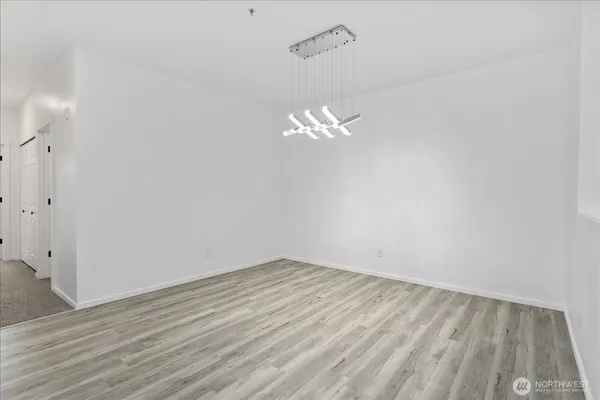 a view of a room with wooden floor and a ceiling fan