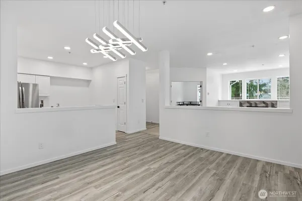a view of a kitchen with an empty space and wooden floor