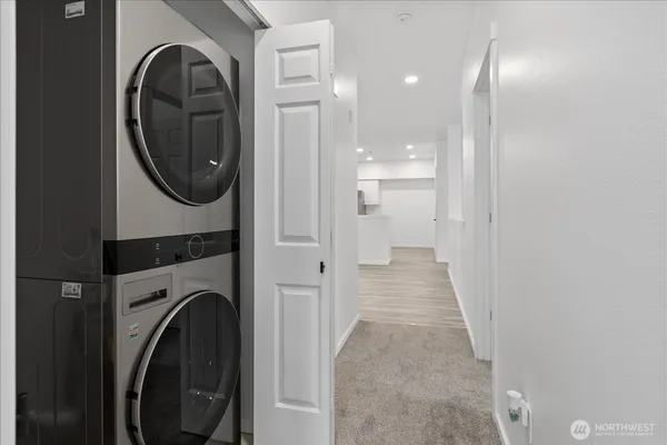 a view of a hallway with washer and dryer