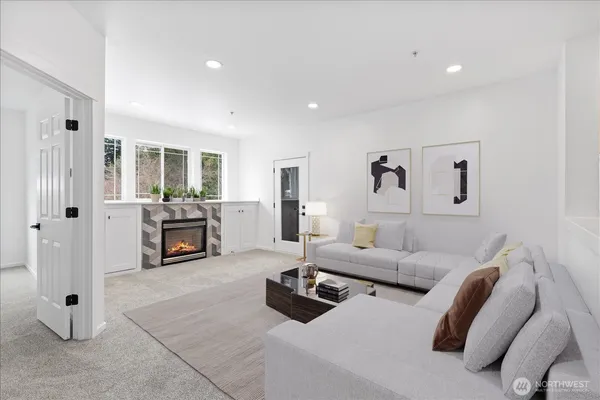 a living room with furniture and fireplace