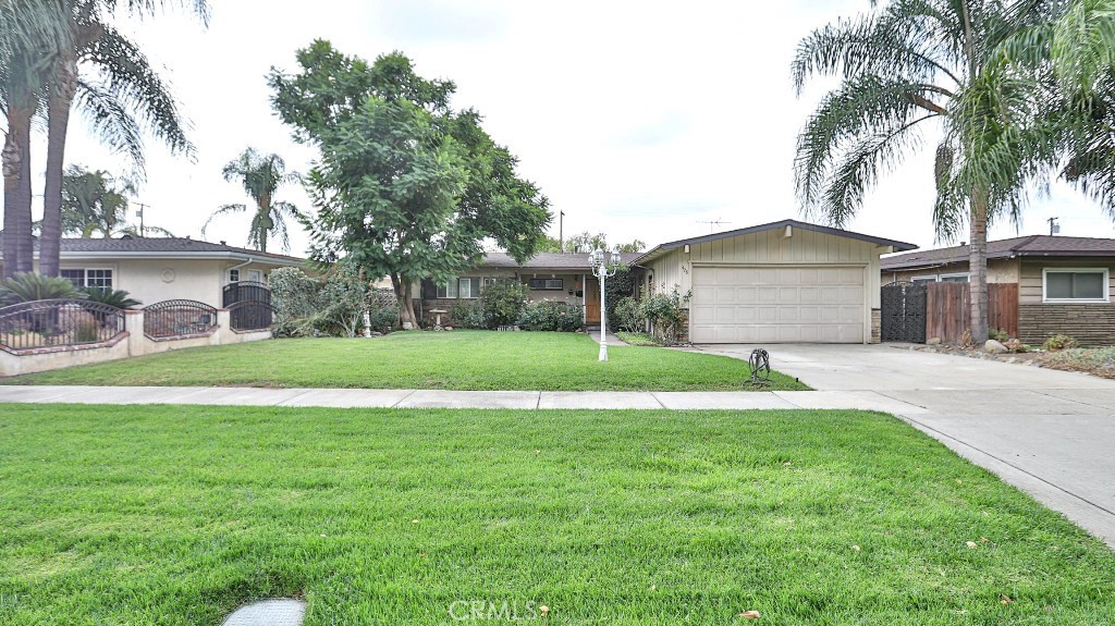 428 West 8th Street Upland, CA 91786 - Photo 1 of 50 a view of a house with a yard and palm trees