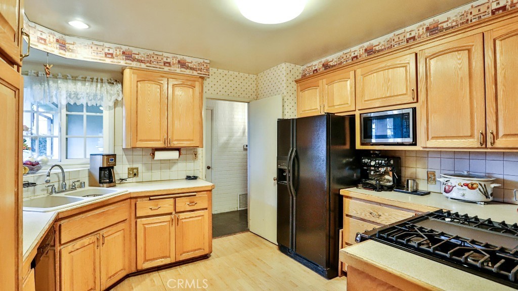 428 West 8th Street Upland, CA 91786 - Photo 25 of 50 a kitchen with stainless steel appliances a stove a sink and a refrigerator