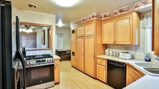 a kitchen with stainless steel appliances a stove and a refrigerator