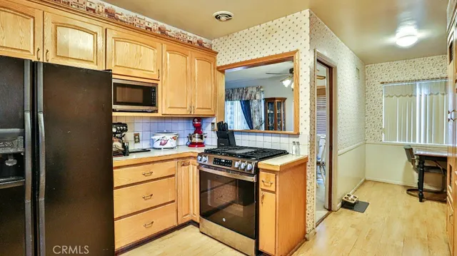 a kitchen with stainless steel appliances granite countertop a stove and a refrigerator