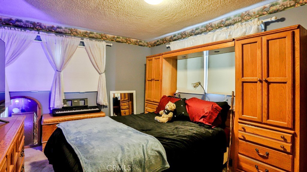 428 West 8th Street Upland, CA 91786 - Photo 33 of 50 a bed sitting in a bedroom next to a window