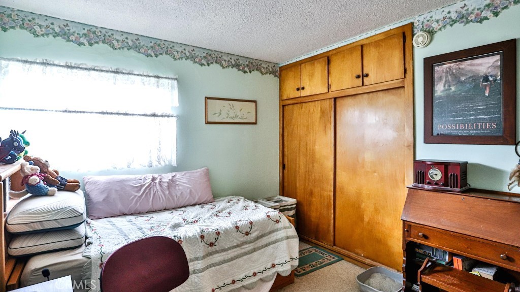 428 West 8th Street Upland, CA 91786 - Photo 42 of 50 a bedroom with a bed and a dresser