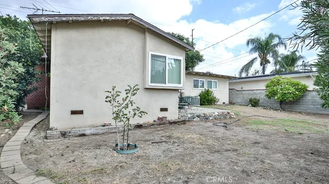 a house that has a tree in front of it