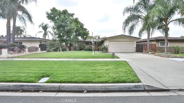 a front view of house with yard and green space