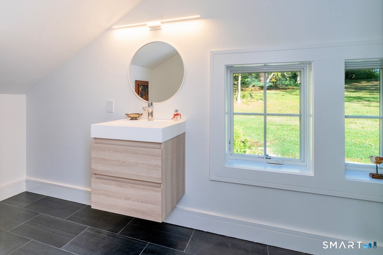 31 Belgo Road Salisbury, CT 06039 - Photo 16 of 25 a bathroom with a sink a mirror and a window
