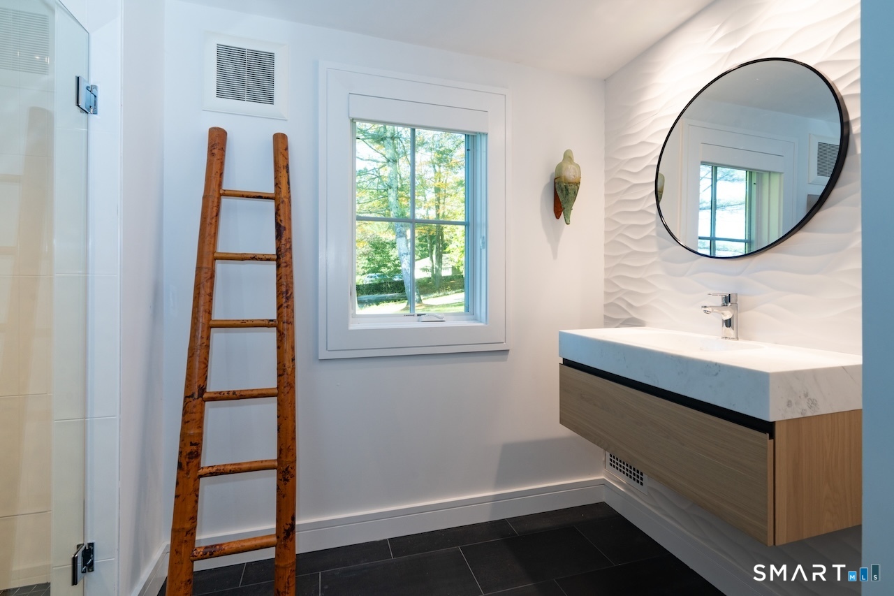 31 Belgo Road Salisbury, CT 06039 - Photo 9 of 25 a bathroom with a sink a mirror and a window