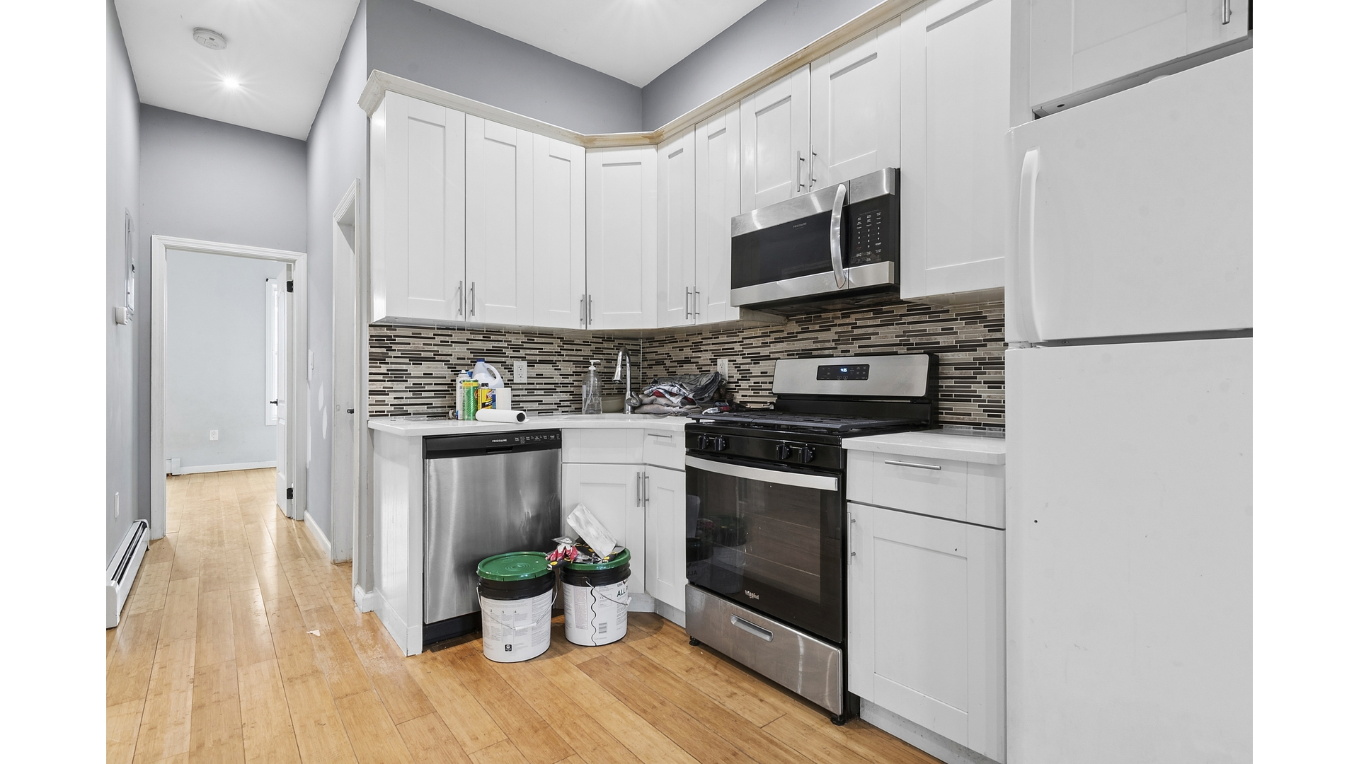 2001 Strauss Street, Unit 2 Brooklyn, NY 11212 - Photo 3 of 6 a kitchen with stainless steel appliances a stove microwave and a refrigerator