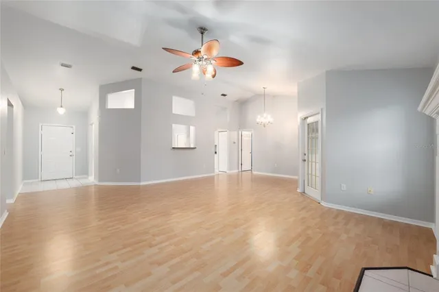 a view of an empty room with a ceiling fan