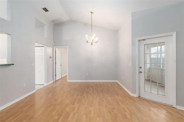 a view of a room with wooden floor and window