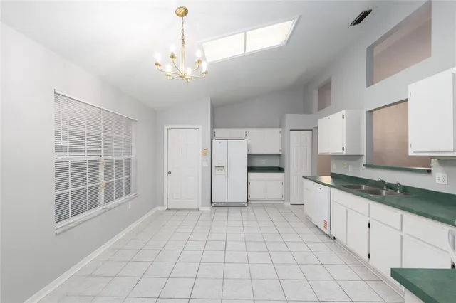a view of a kitchen with a sink and dishwasher cabinets