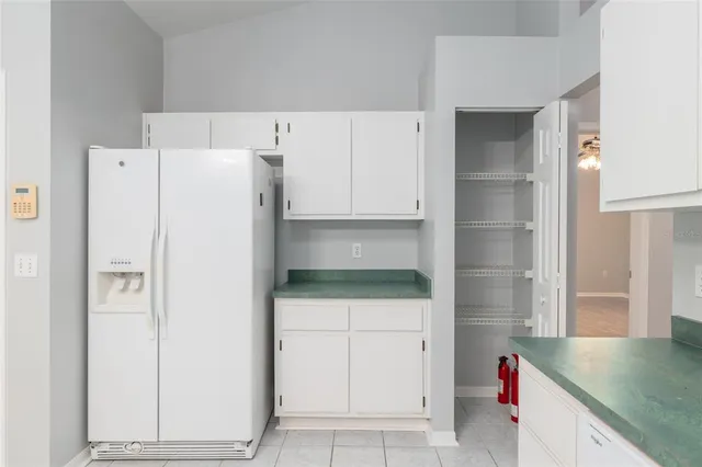 a kitchen with a refrigerator and a sink