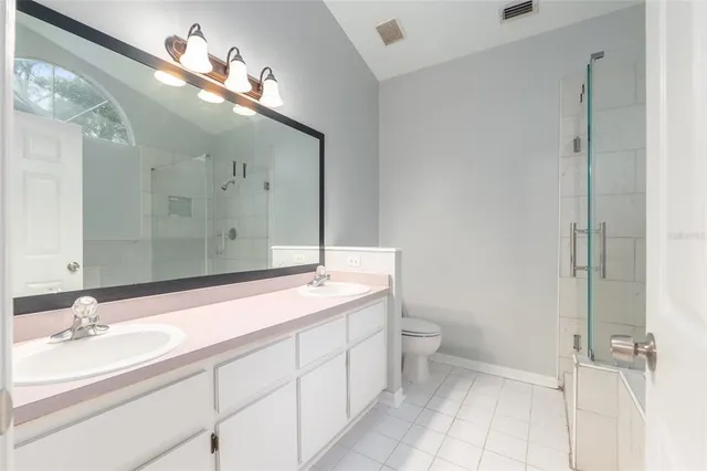 a bathroom with a double vanity sink and a mirror