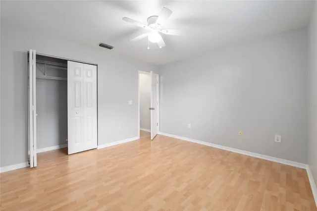 a view of an empty room with a ceiling fan