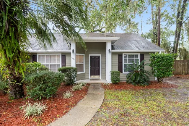 a front view of a house with a garden