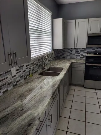 a kitchen with a sink stove and cabinets