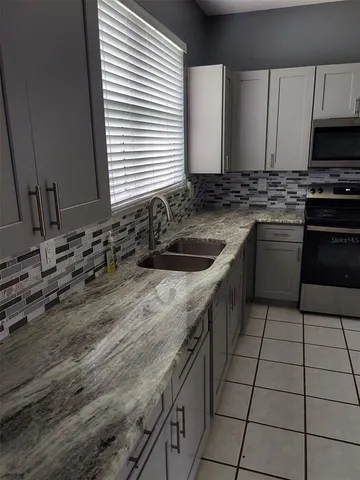 a kitchen with a sink stove and cabinets