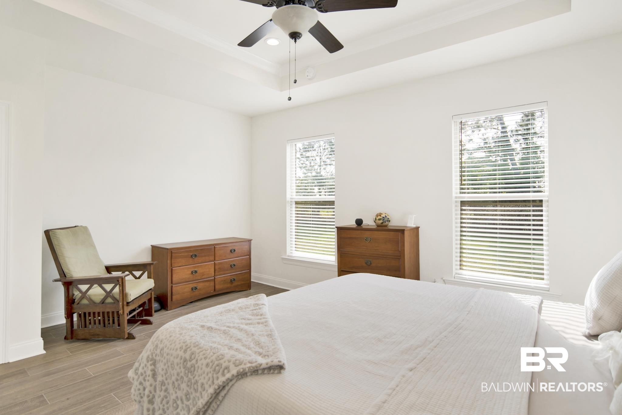22258 Hibiscus Circle Foley, AL 36535 - Photo 16 of 26 Bedroom with light wood-style flooring, a tray ceiling, recessed lighting, baseboards, and ceiling fan