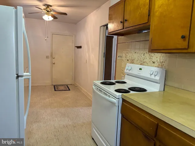 a kitchen with a stove and a refrigerator