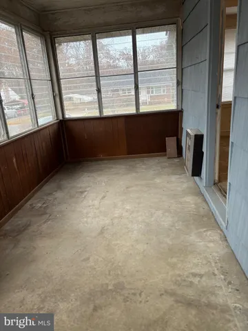 an empty room with large windows