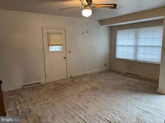 an empty room with a empty space and windows