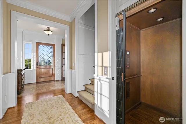 a view of a hallway with wooden floor and windows