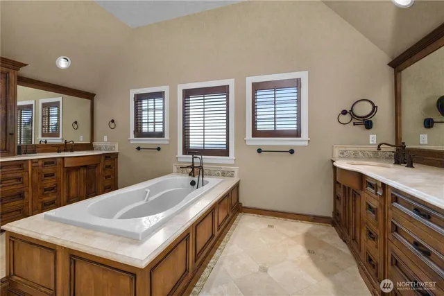 a spacious bathroom with a sink double vanity and a mirror
