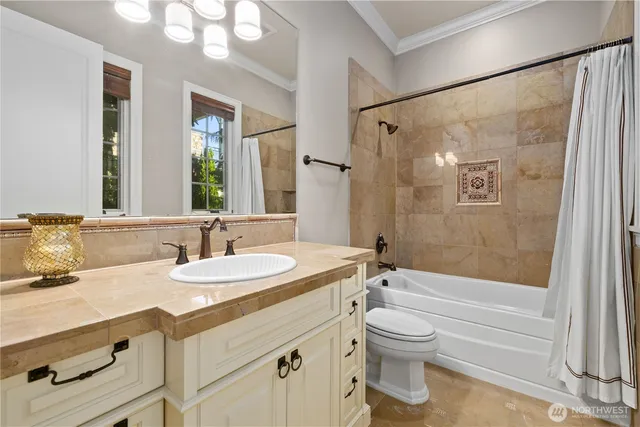 a bathroom with a granite countertop sink toilet a large mirror a bathtub and shower