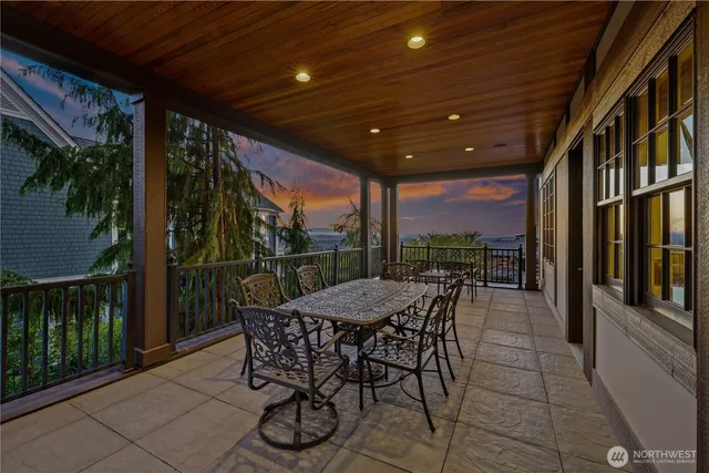 a view of a patio with a table chairs and backyard