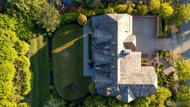 an aerial view of a house with garden space and street view
